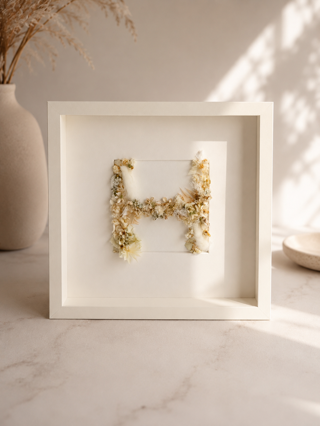 Personalised floral letter frame — a single initial shaped from real 3D preserved flowers, 25x25cm, made in the UAE