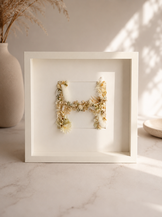 Personalised floral letter frame — a single initial shaped from real 3D preserved flowers, 25x25cm, made in the UAE